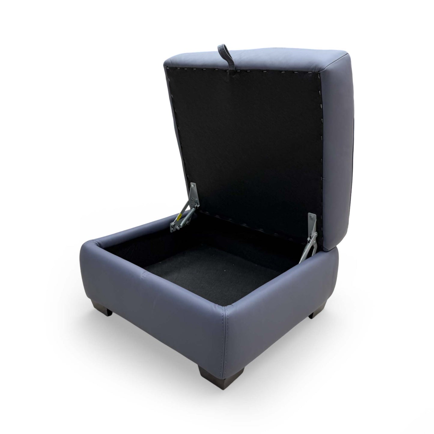 Detailed shot of the interior lining and hinge mechanism of the storage footstool.