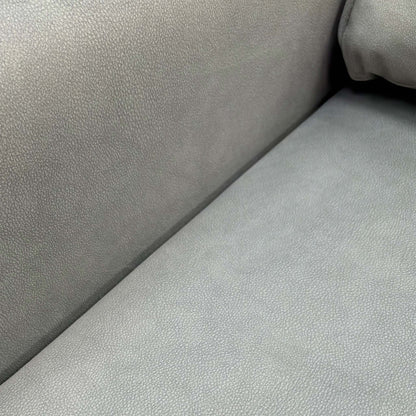 Close-up of the grey velvet fabric and deep buttoning detail on the backrest of the 'Zoom' chair bed.