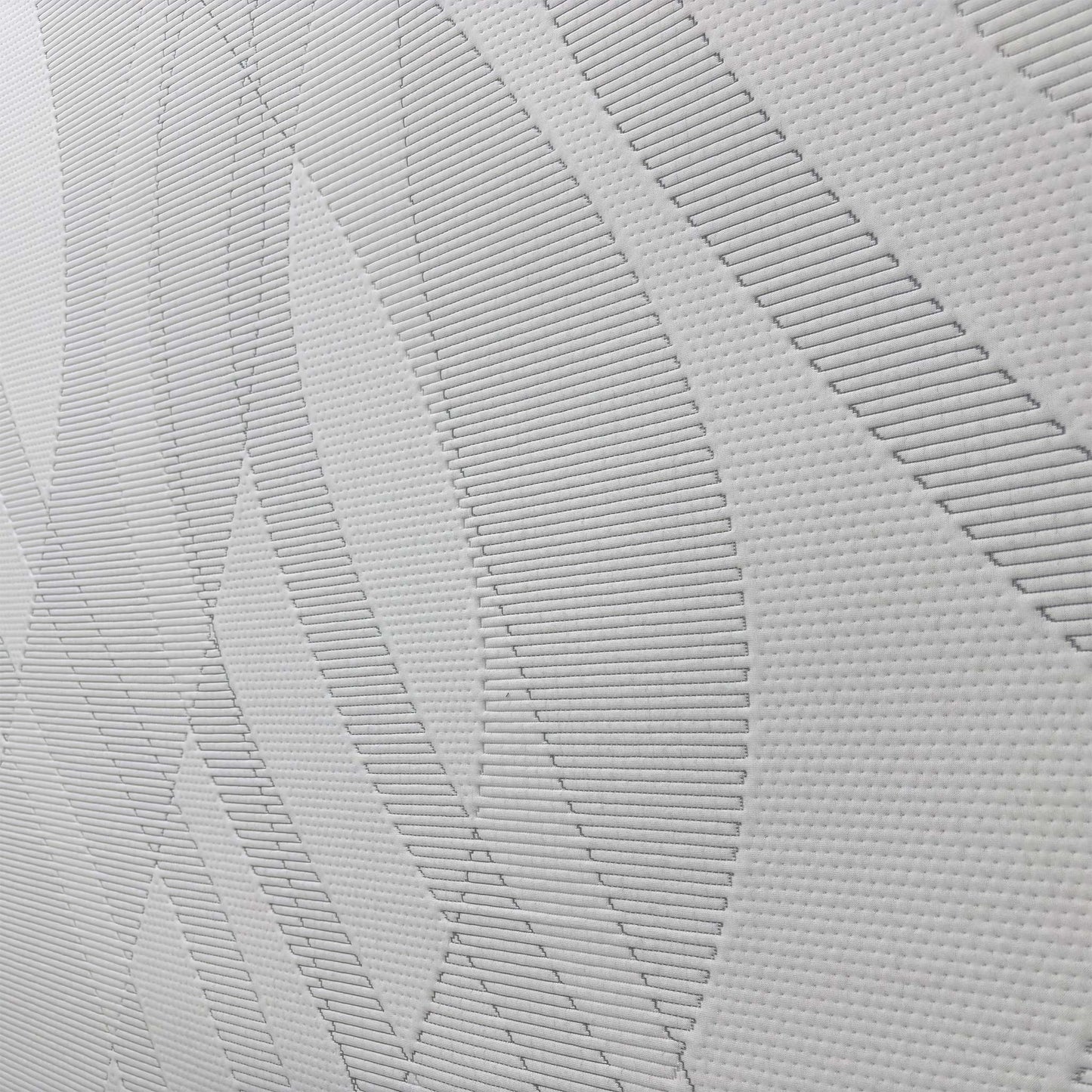 Detailed close-up of the mattress fabric, demonstrating the high-quality finish and comfort layers that minimize motion transfer.