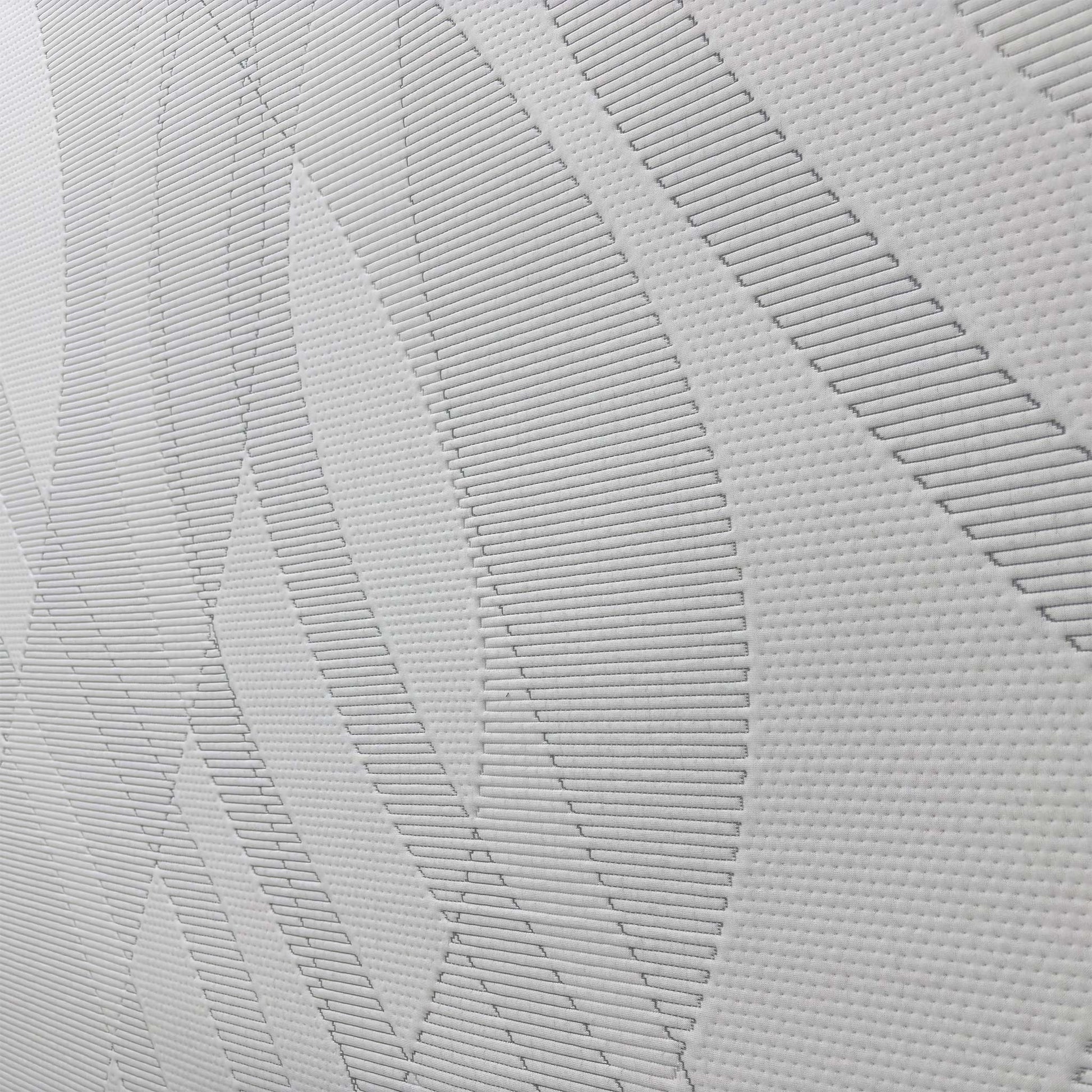Detailed close-up of the mattress fabric, demonstrating the high-quality finish and comfort layers that minimize motion transfer.