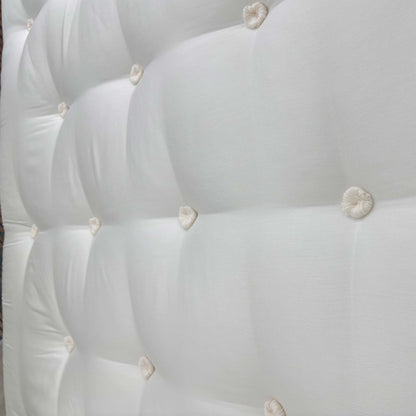 Detailed close-up of the mattress surface and tufted finish, demonstrating the high-performance materials and wool-rich comfort layer.