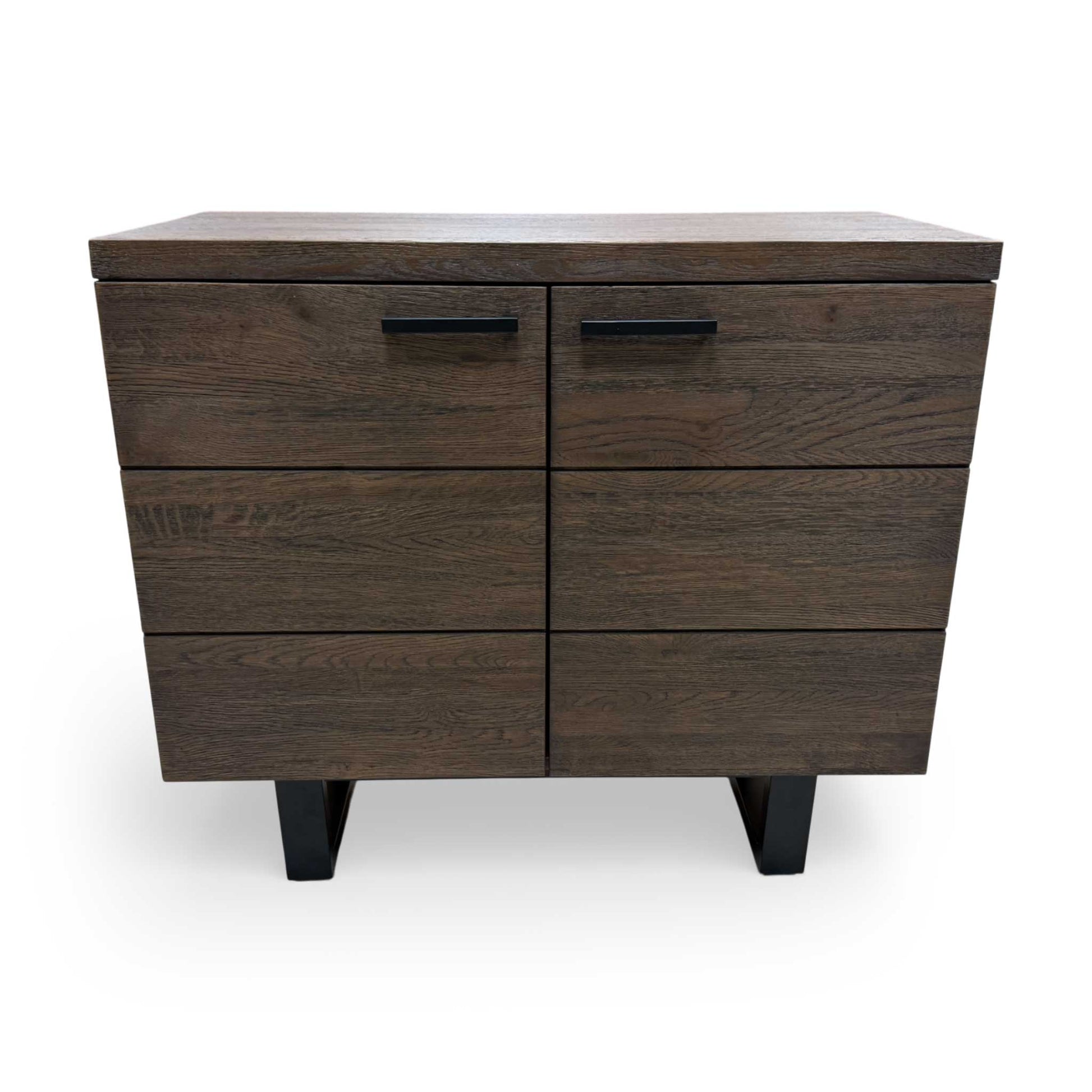 Interior compartment of the small sideboard with doors open, showing the spacious storage area for linens, tableware, or books.