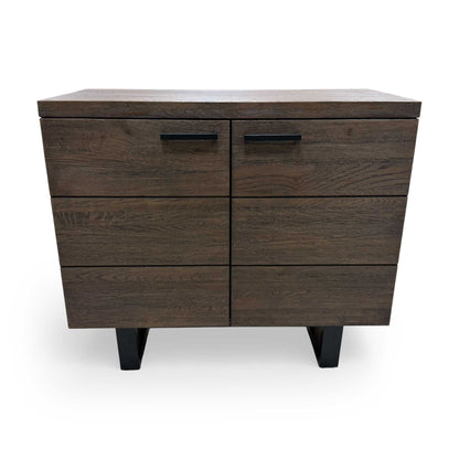 Interior compartment of the small sideboard with doors open, showing the spacious storage area for linens, tableware, or books.