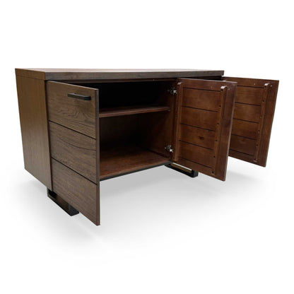 Interior view of the sideboard with doors open, showing the generous storage compartments and adjustable wooden shelving.