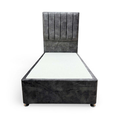 Front view of the single divan bed, highlighting the sophisticated grey velvet upholstery and detailed headboard stitching.