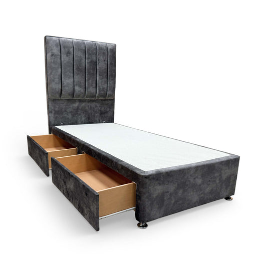 Front view of single bed featuring a tall, floor-standing headboard with lace domino velvet detailing and a matching grey divan base.