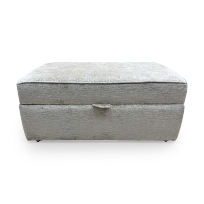 Front view of Sasha footstool with the lid open, revealing a spacious internal storage compartment for cushions and blankets.