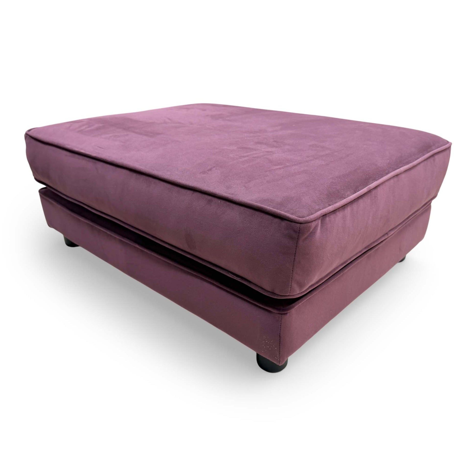 Side-angle view of the Isobel footstool, emphasizing the generous surface area and sophisticated velvet upholstery.