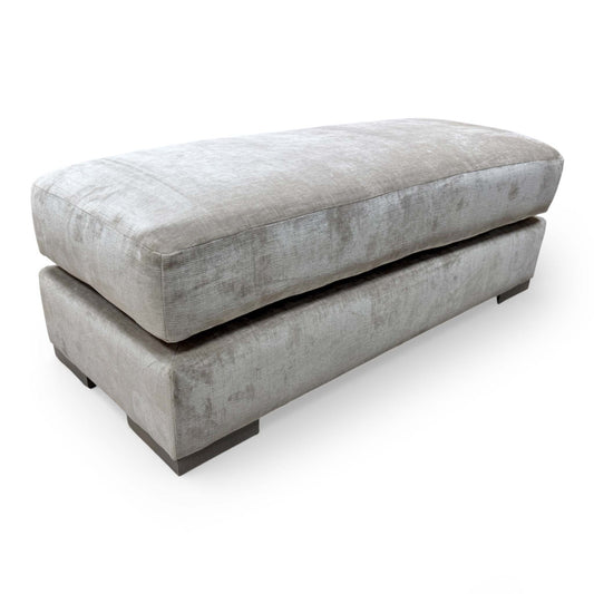 Front-facing view of the Jackson Large Footstool, emphasizing the smooth velvet upholstery and sturdy, contemporary silhouette.