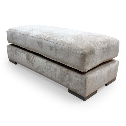 Side view of the Jackson velvet bench, showcasing the clean lines and uniform cushioning of the footstool.