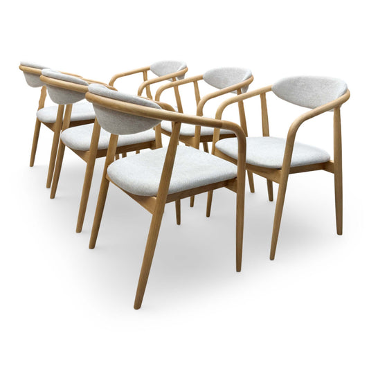 Front-facing view of a single G Plan Winchester arm chair, highlighting the curved wooden armrests and plush grey fabric seat.