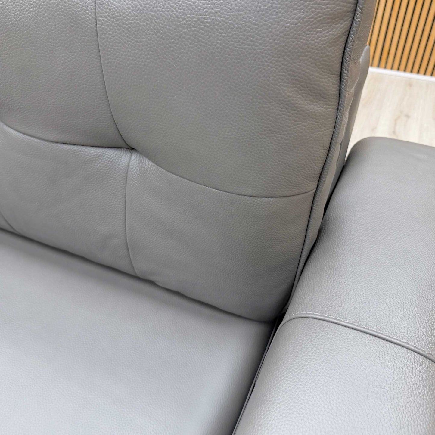 Close-up shot of the Zoom grey leather upholstery, highlighting the high-quality grain and finish.