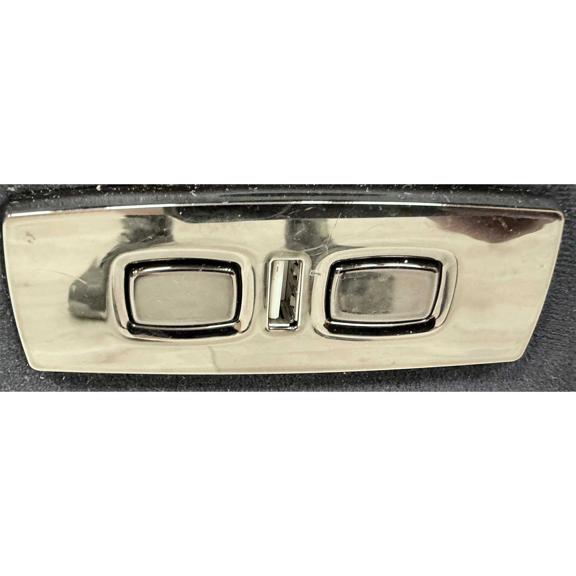 Close-up of the integrated power controls located on the side of the sofa armrest.