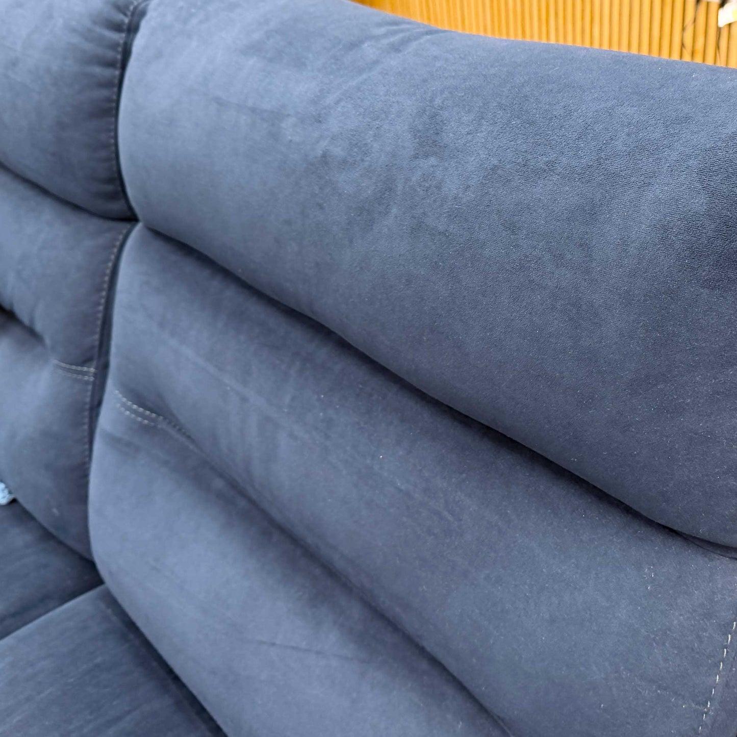 Detailed close-up of the luxurious navy blue velvet upholstery and side stitching on the Berlin sofa.