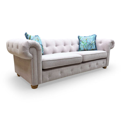 Front view of the lilac Belair sofa, demonstrating the symmetry of the rolled arms and the sophisticated aesthetic of the Plaza Linen collection.