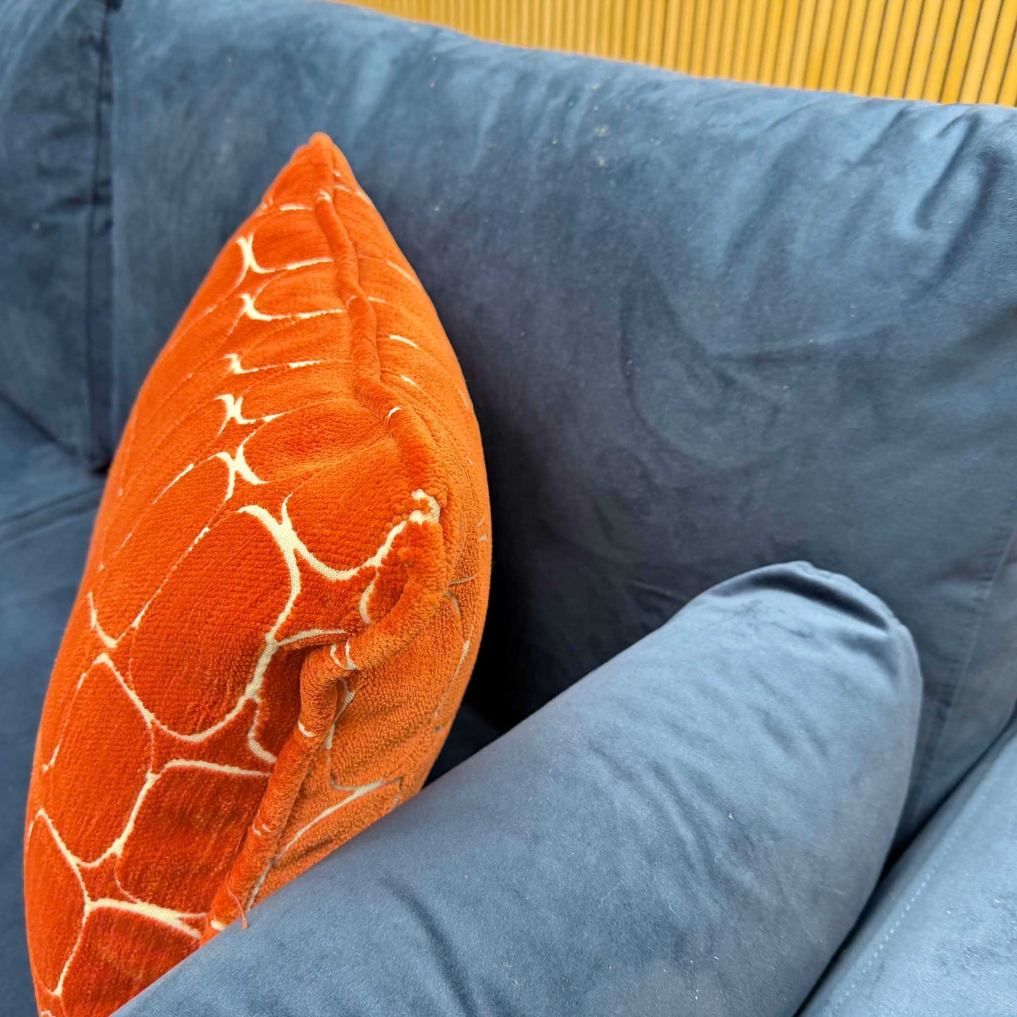 Close-up shot of the ‘Wren’ sofa, highlighting the rich texture of the Navy Blue velvet fabric and the precise stitching along the edge of the formal back and seat cushions.