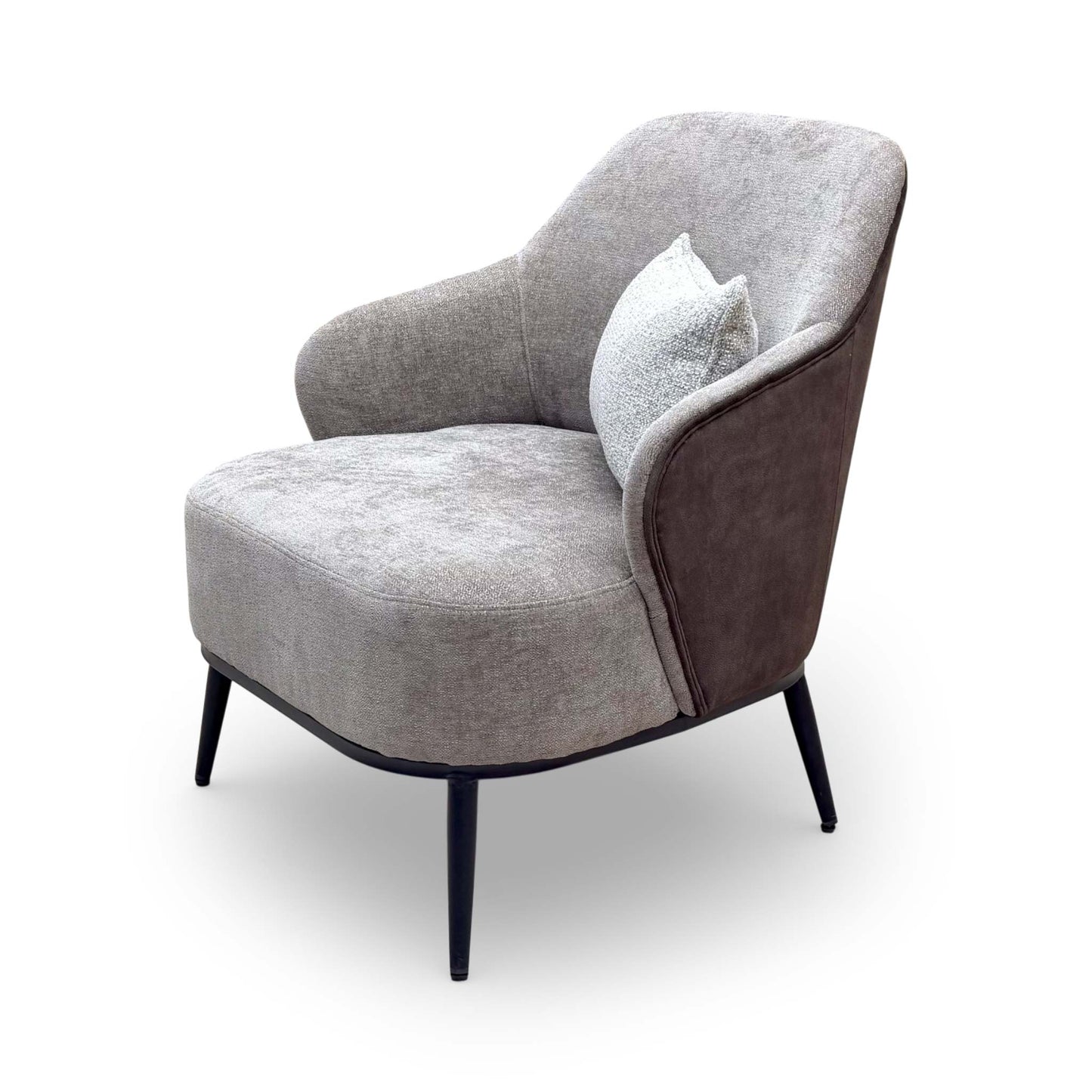 Angled view of the ‘Velar’ snuggler-style accent chair, emphasizing its compact yet inviting seating area.