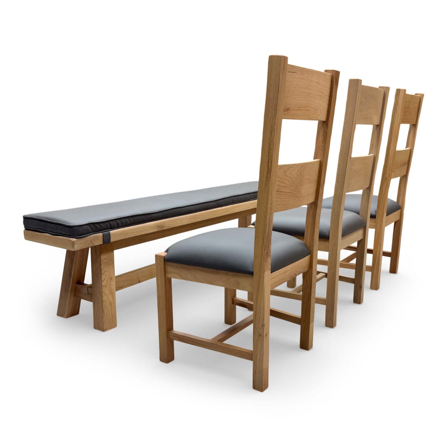 Side view of the Delaney dining bench with its grey faux leather seat pad, designed for comfortable group seating.