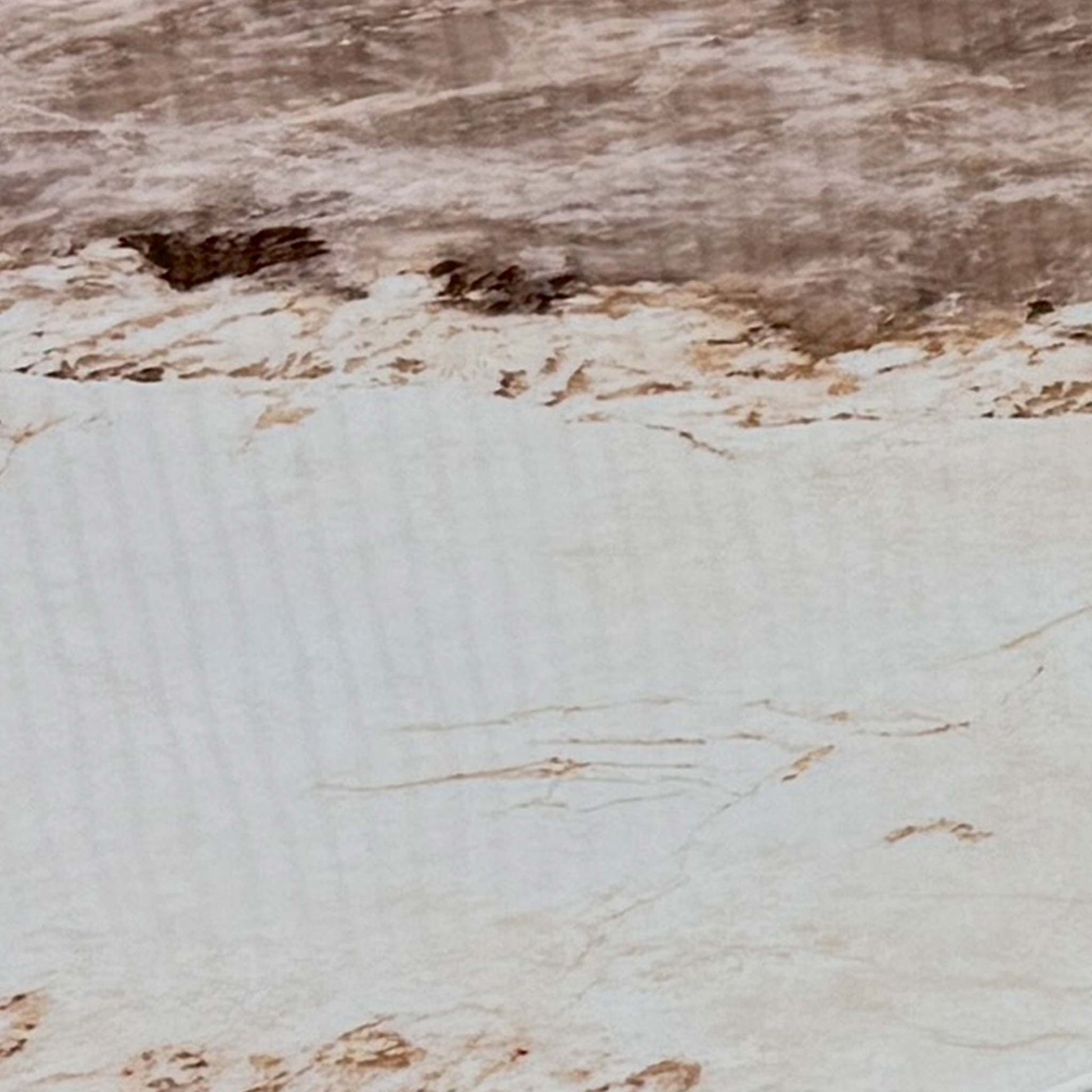 Close-up of a corner of the polished mocha marble tabletop, illustrating the smooth finish and premium quality of the real stone.