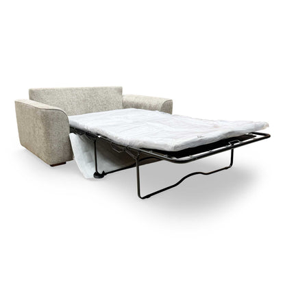 View of the sofa bed partially opened, highlighting the ease of use for the sleep mechanism.
