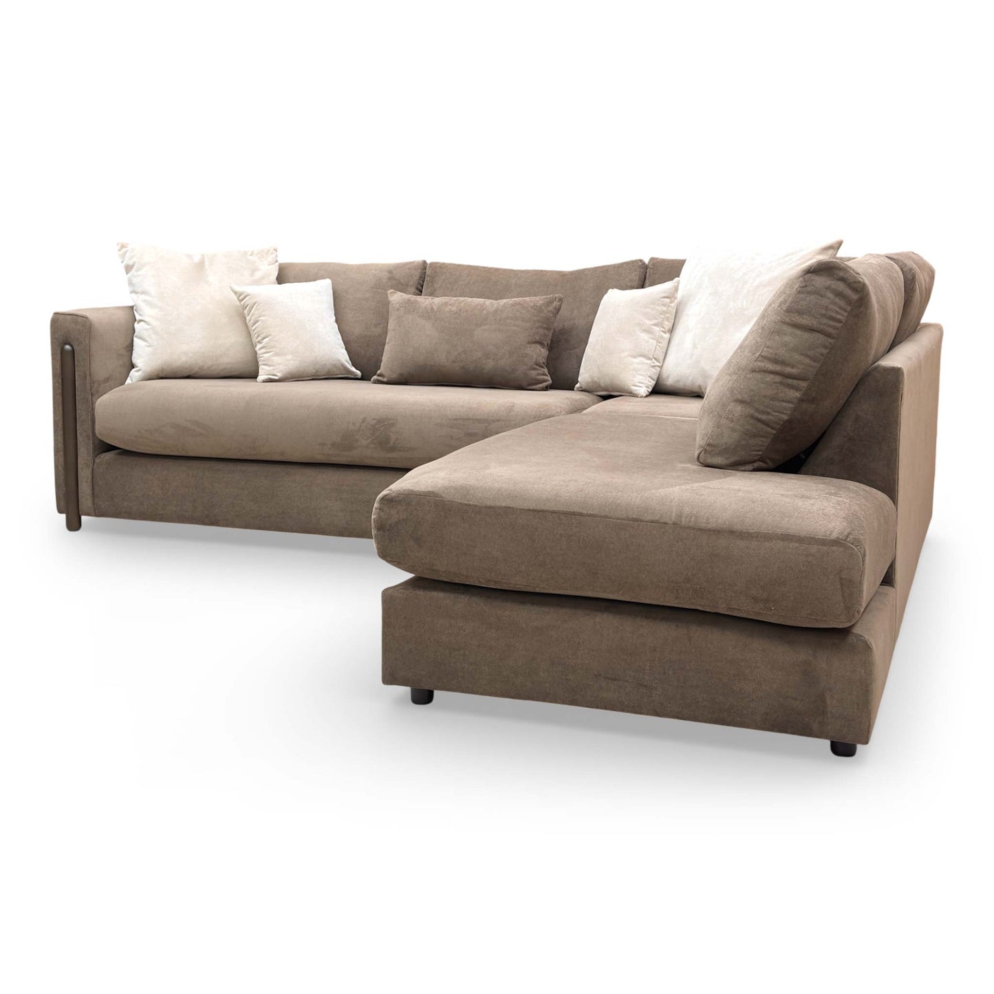 Angle shot focusing on the formal back cushions and structured armrests of the Barney sofa.