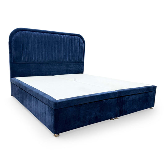 Full view of the Highgrove ‘Portland’ Super King Bed featuring a tall, floor-standing navy fabric headboard and a matching electric ottoman divan base.