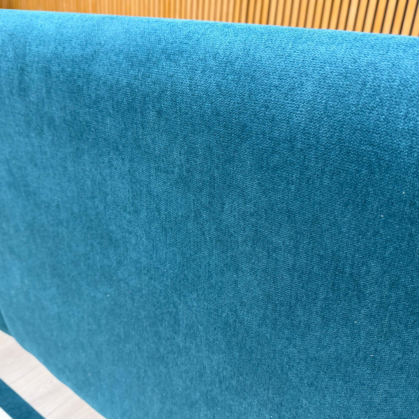 Close-up of the New Teal upholstery on the Bella headboard, highlighting the rich blue-green color and the soft, premium fabric texture.