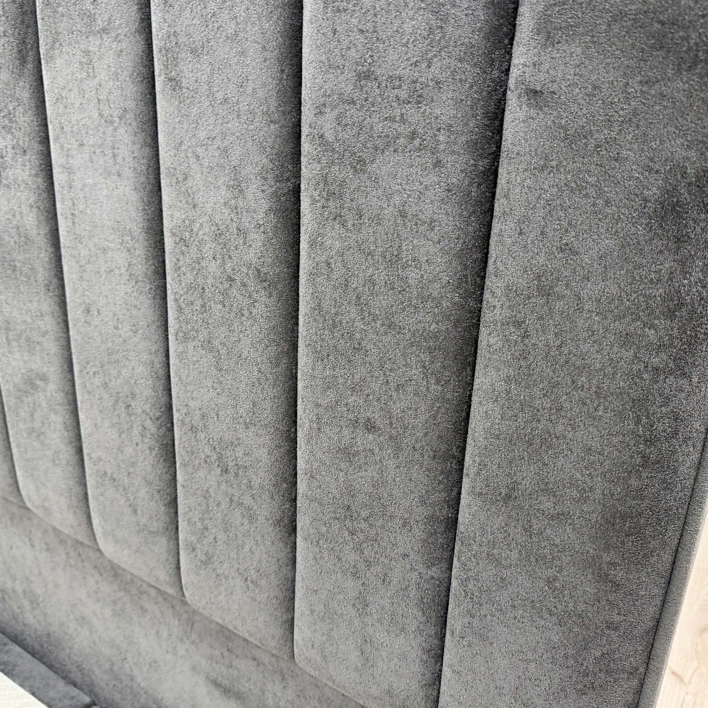 Close-up of the Milan Thunder velvet fabric, showcasing the soft texture and deep charcoal-gray tone used on the ‘Pluto’ bed set.