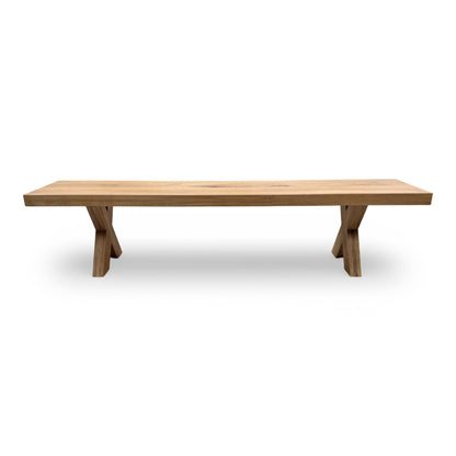 Detailed shot of the wooden X-shaped leg assembly, emphasizing the craftsmanship and structural integrity of the bench.