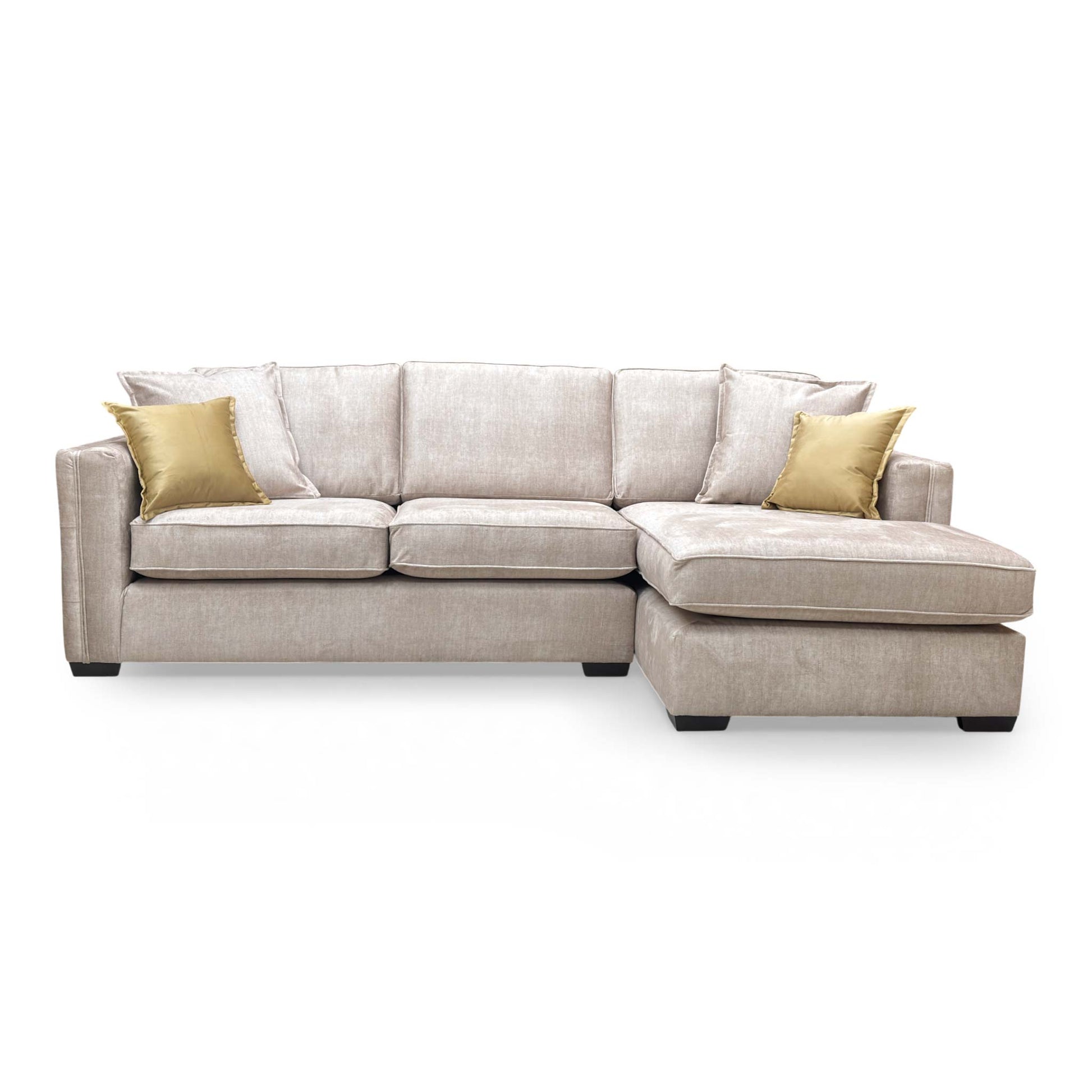 Front angle of the beige velvet Chelsea corner chaise, showing the spacious lounging area and modern English arm style.