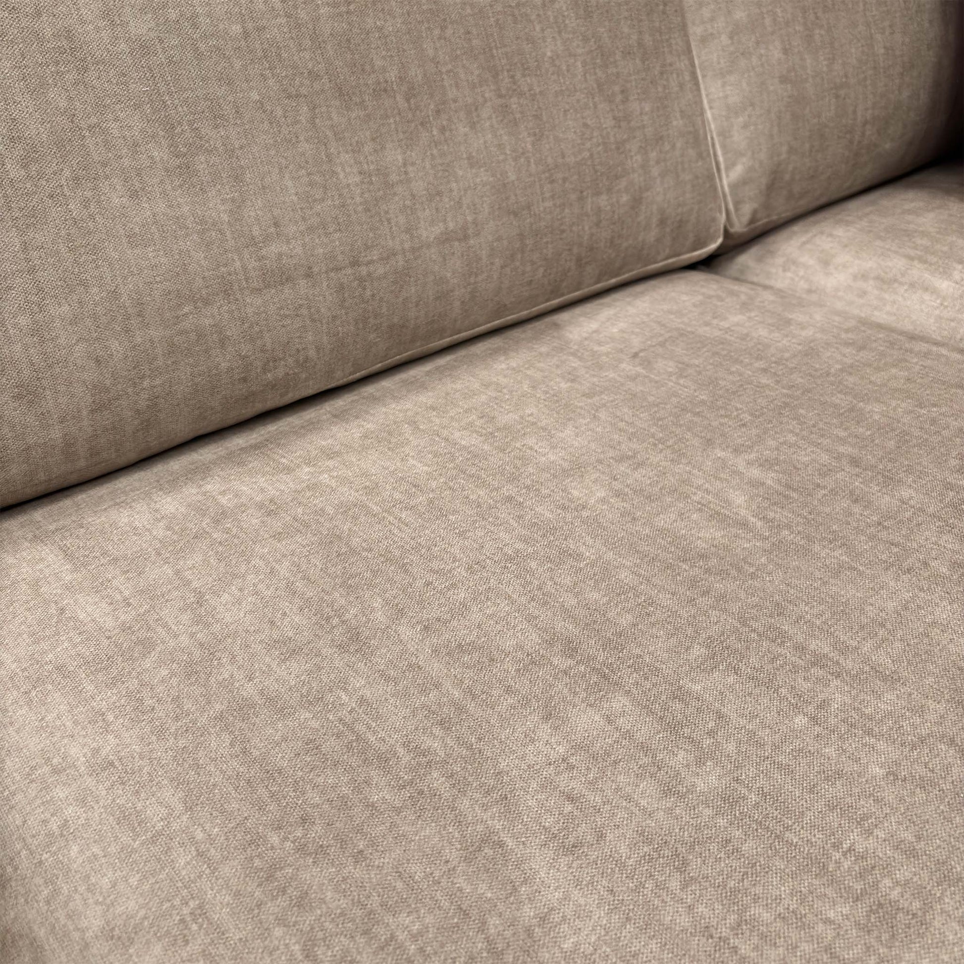 Close-up shot of the beige Vogue velvet upholstery, illustrating the high-quality finish and soft-touch feel of the fabric.