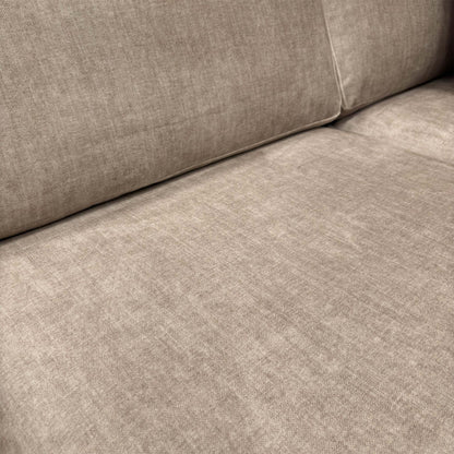 Close-up shot of the beige Vogue velvet upholstery, illustrating the high-quality finish and soft-touch feel of the fabric.