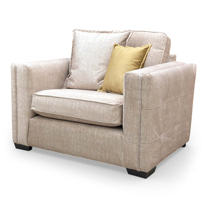 Side profile of the Chelsea snuggler chair, emphasizing the depth of the seat and the clean lines of its contemporary wooden frame.