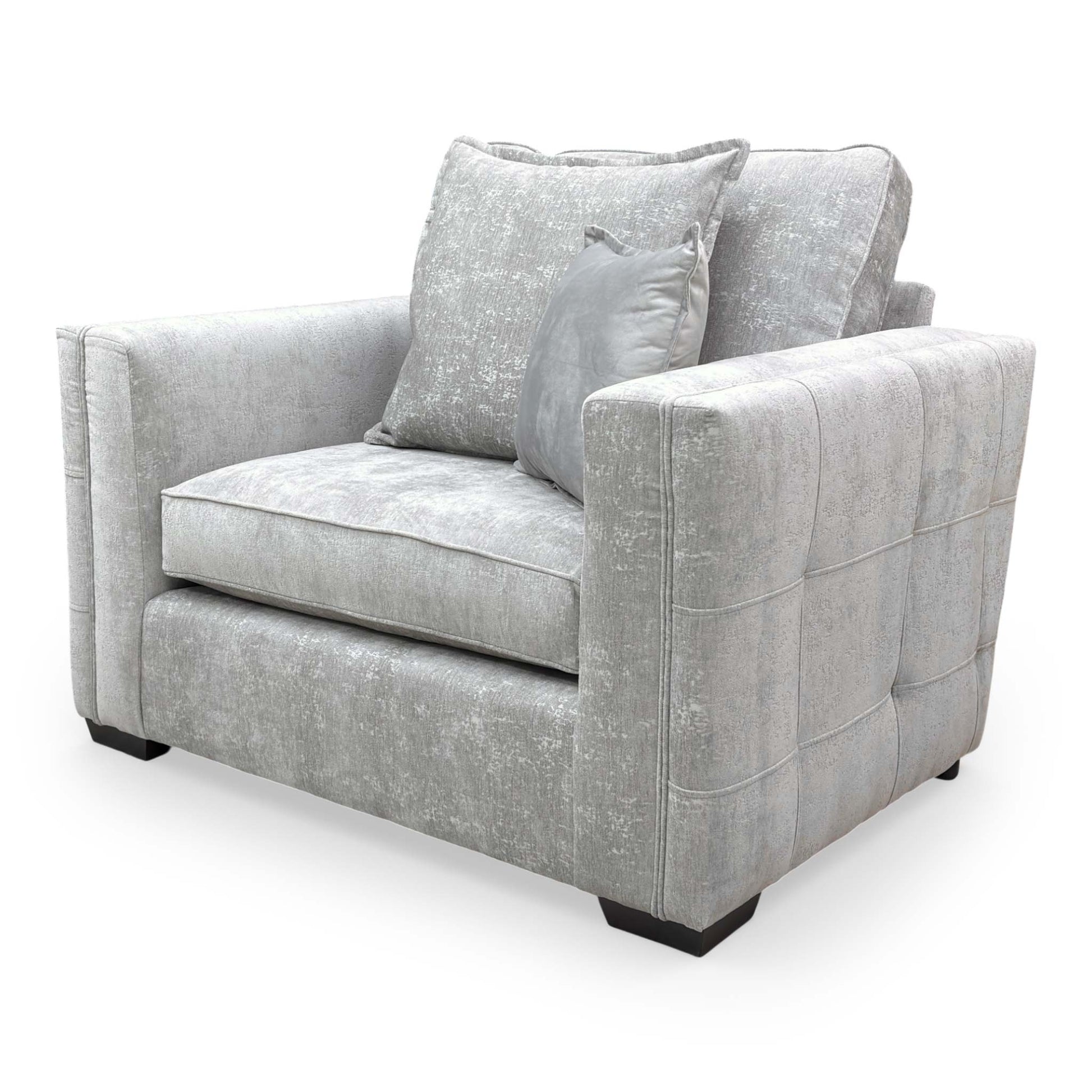 Side profile of the Chelsea snuggler chair, showing the depth of the seat and the sleek lines of the wooden frame.