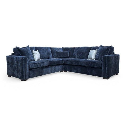 Front-facing view of the 'Chelsea' 2 Corner 2 sofa in Denim Derwent soft weave fabric, showing the symmetrical corner design and plush scatter cushions.
