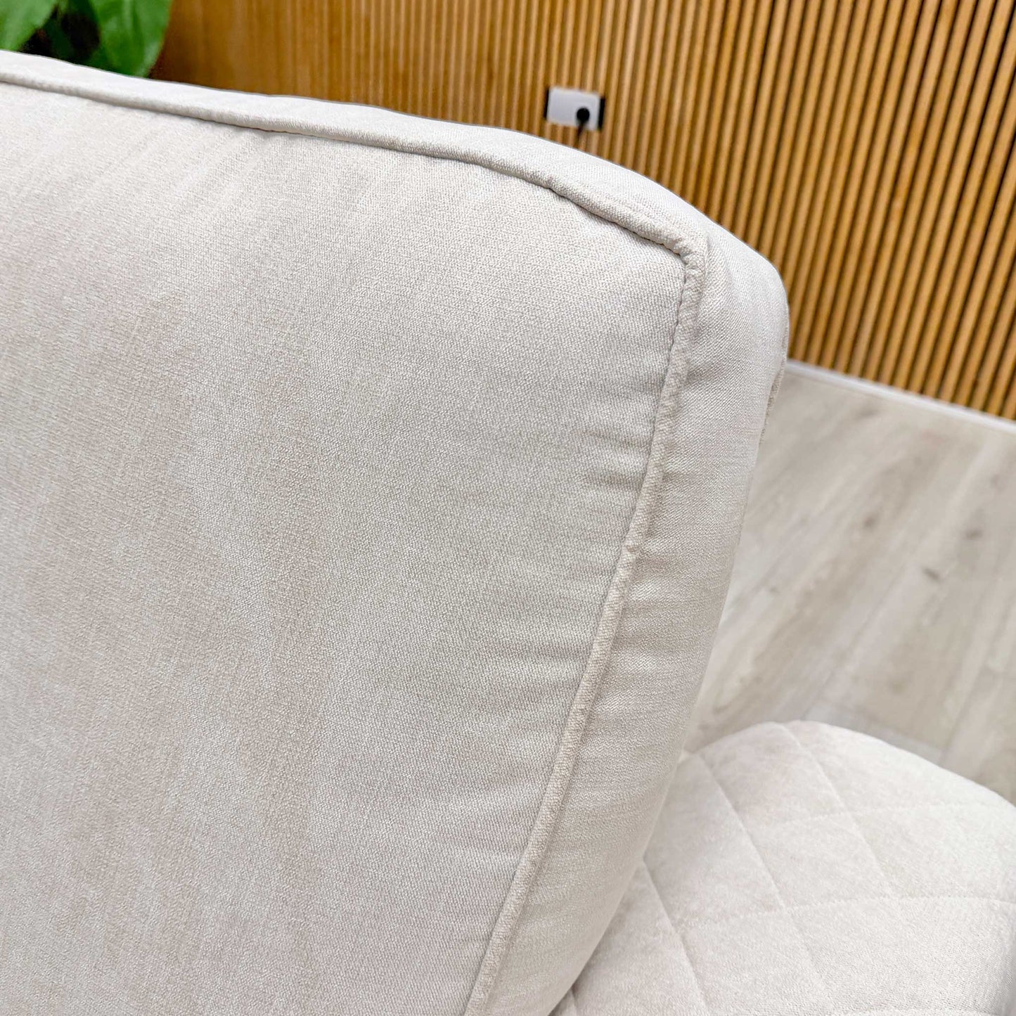 Close-up of the power recliner controls on the side of the sofa, featuring a convenient button for easy adjustment.