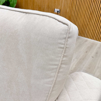 Close-up of the power recliner controls on the side of the sofa, featuring a convenient button for easy adjustment.