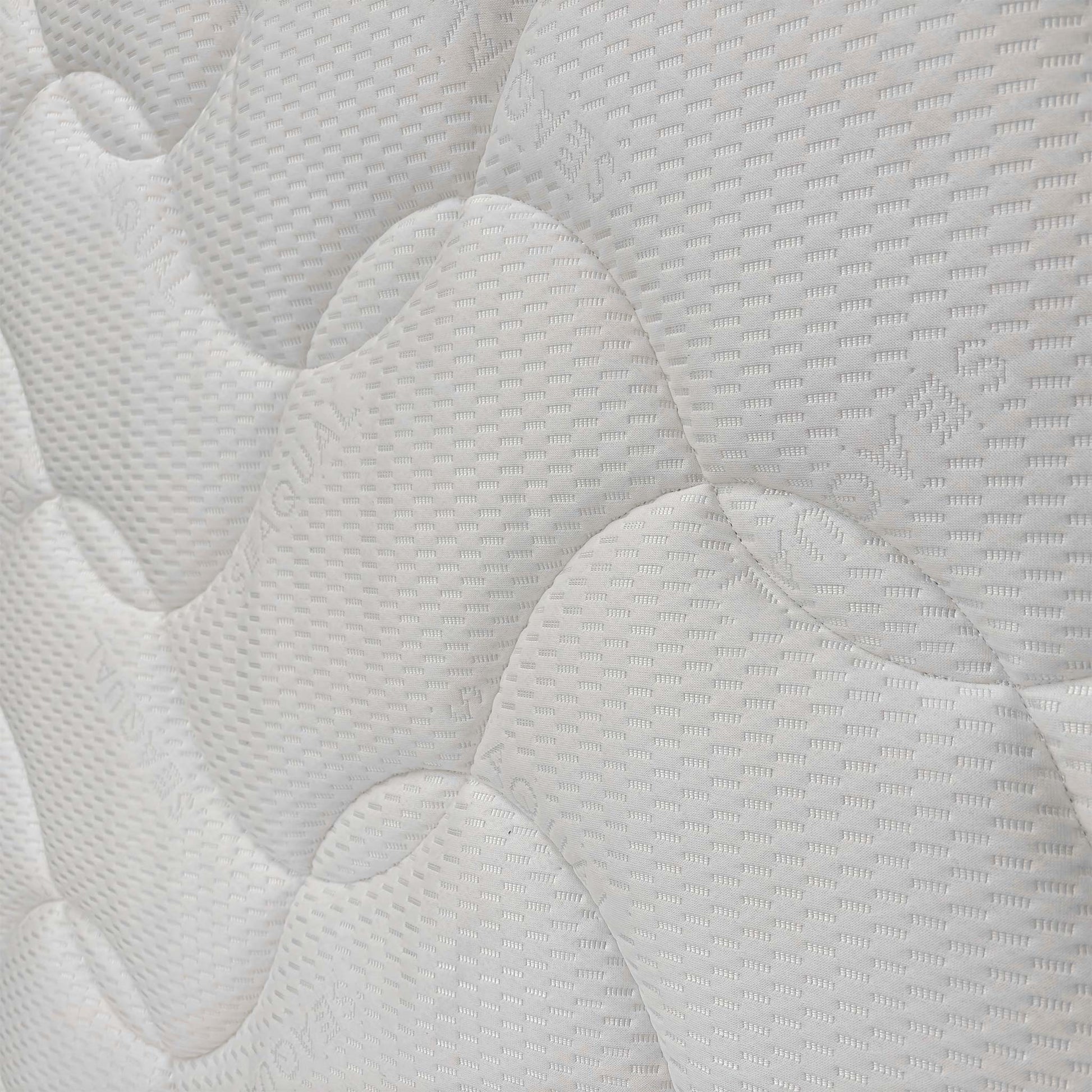 Close-up of the quilted mattress surface, detailing the high-quality fabric texture designed for comfort and airflow.