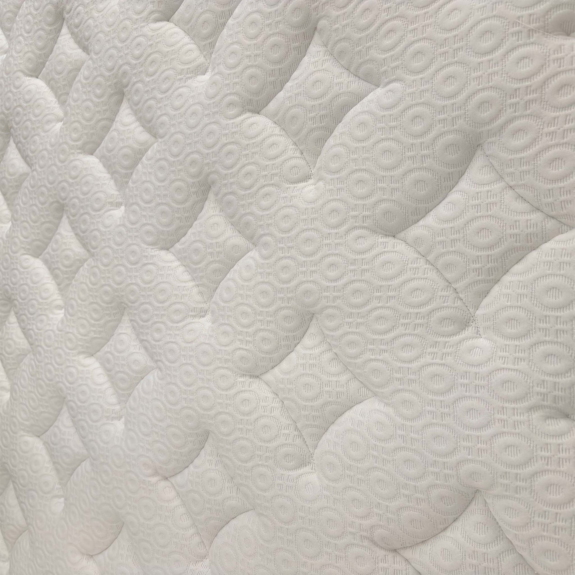 Detailed shot of the quilted surface, emphasizing the soft-touch fabric and integrated memory foam for pressure relief.