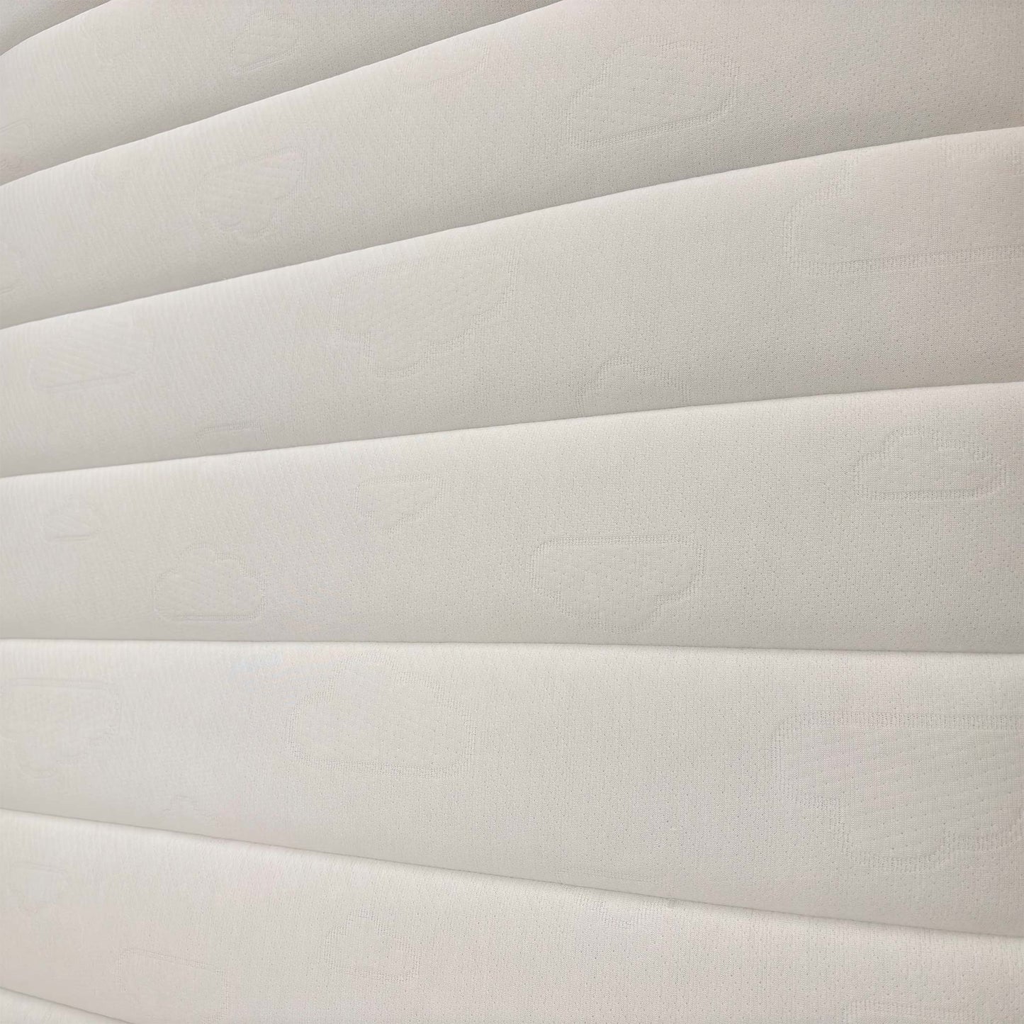 Detailed shot of the mattress quilting, showcasing the breathable materials designed for restorative sleep and spinal alignment.