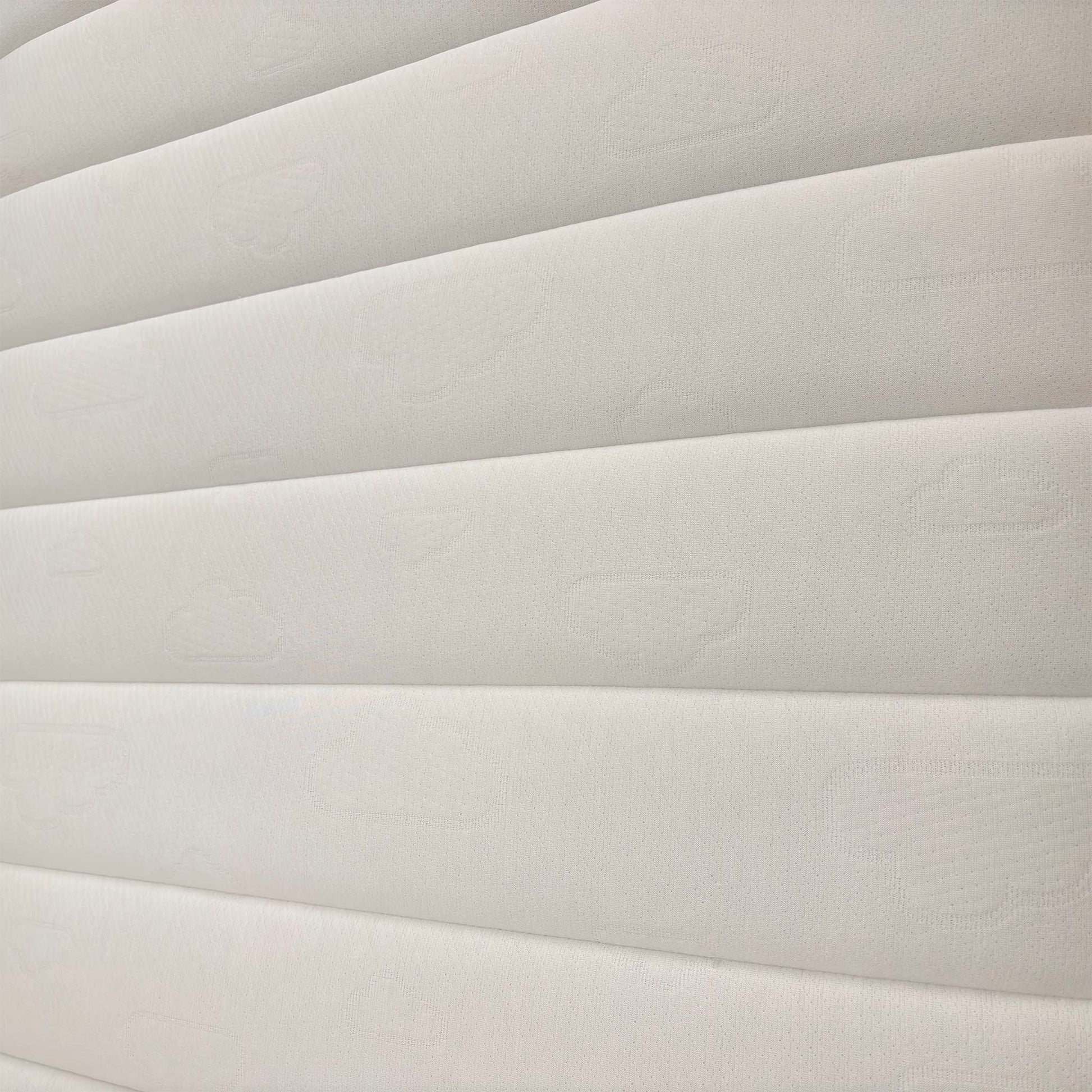 Detailed shot of the mattress quilting, showcasing the breathable materials designed for restorative sleep and spinal alignment.
