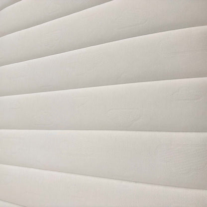 Detailed shot of the mattress quilting, showcasing the breathable materials designed for restorative sleep and spinal alignment.