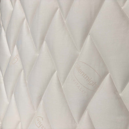 Close-up of the tufted mattress surface, detailing the soft-touch fabric designed for pressure relief and spinal alignment.