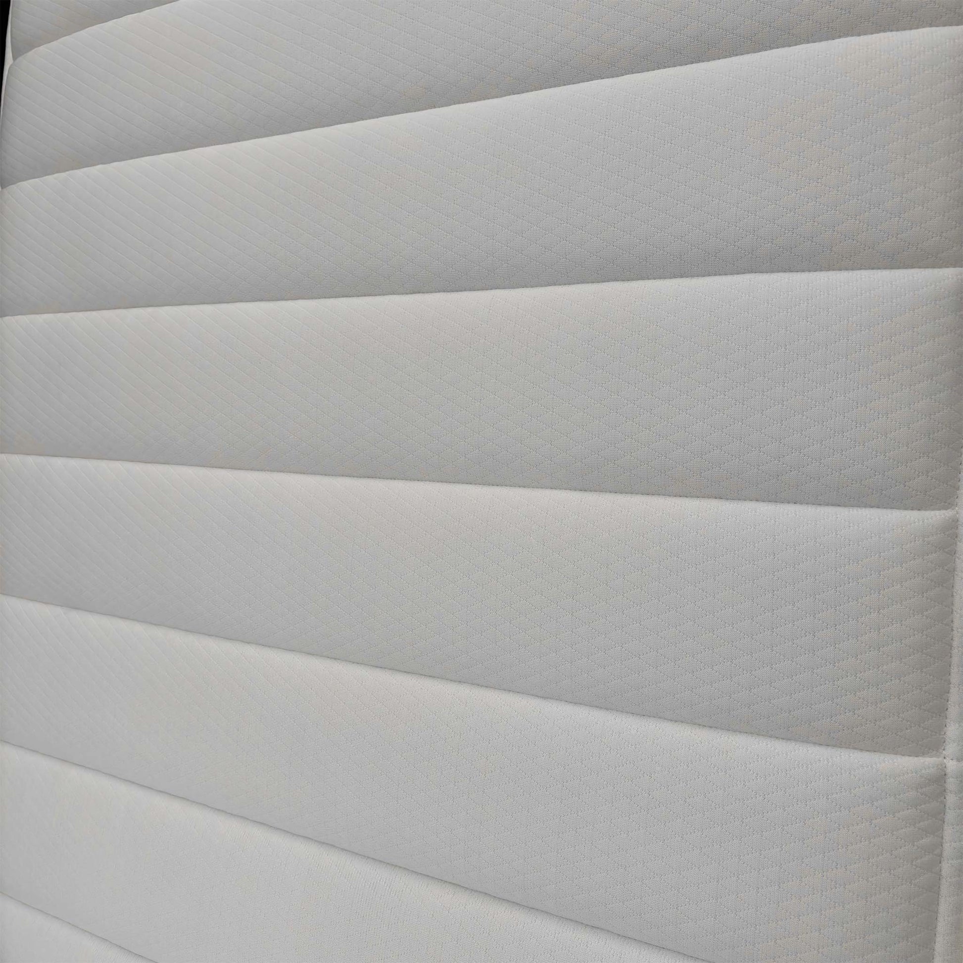 Detailed shot of the top fabric, highlighting the hypoallergenic materials designed for a healthy sleep environment for children.