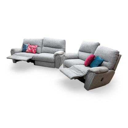 Side profile of the 'Willow' grey fabric sofas, illustrating the supportive backrests and deep-seated comfort of the reclining mechanism.