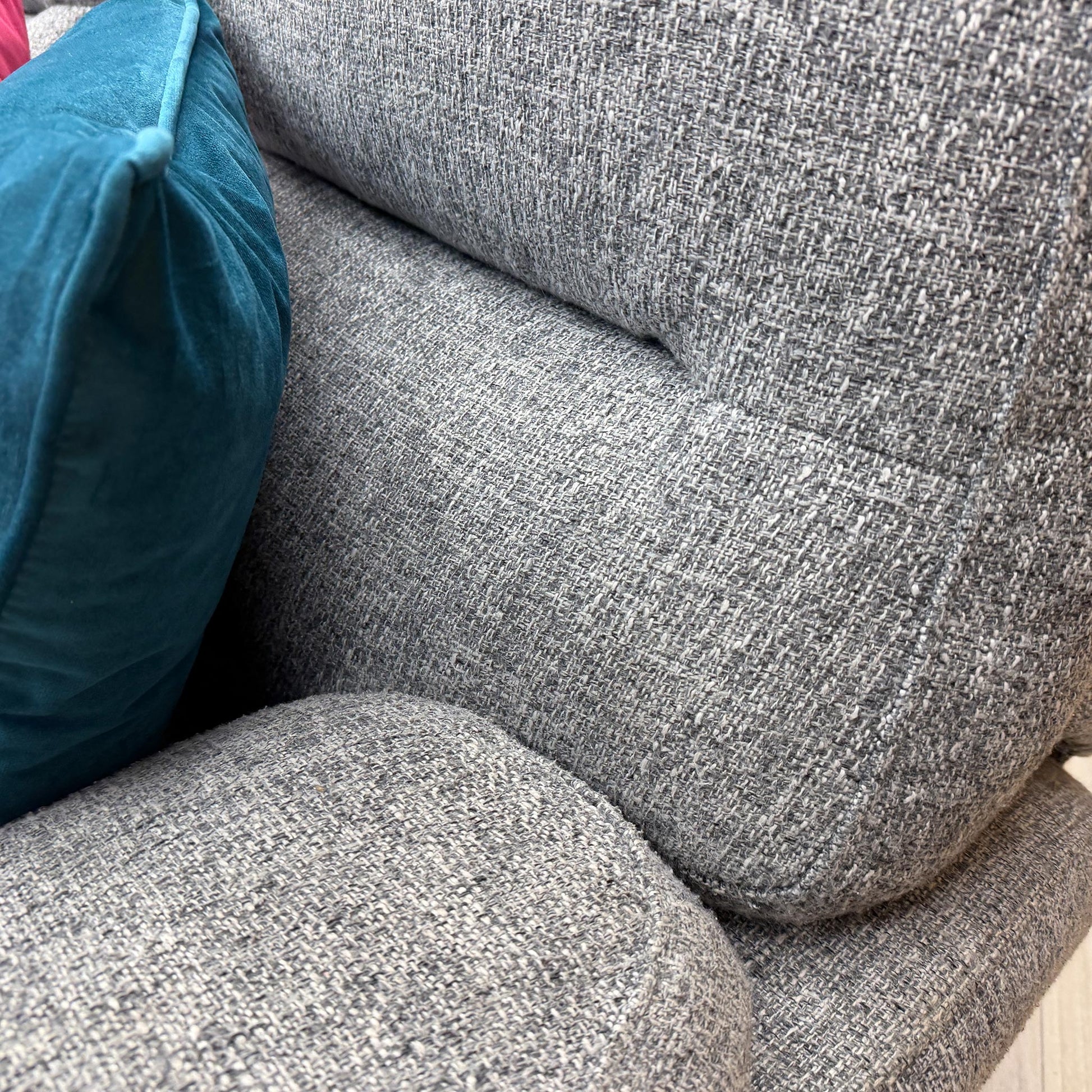 Close-up of the durable grey fabric material used on the 'Willow' sofa set, showcasing the high-quality weave and soft texture.