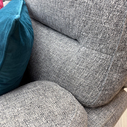 Close-up of the durable grey fabric material used on the 'Willow' sofa set, showcasing the high-quality weave and soft texture.