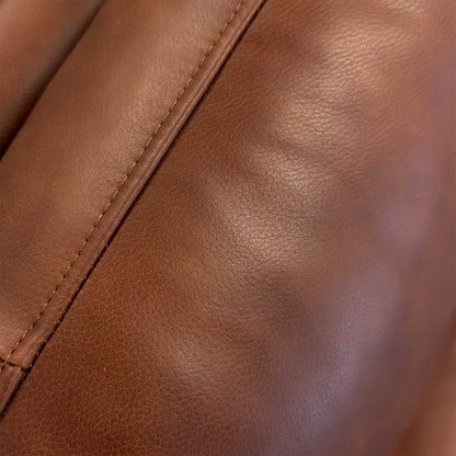 Close-up of the Butterscotch leather upholstery, detailing the high-grade natural grain, soft texture, and precision seam stitching.
