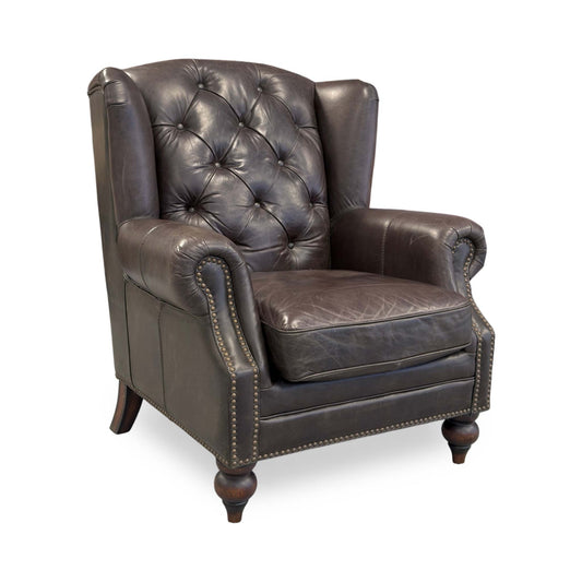 Full view of the At The Helm Shackleton Wing Chair in Cannon Dark Brown leather, featuring a classic high-back silhouette with deep button tufting and hand-finished stud detailing.