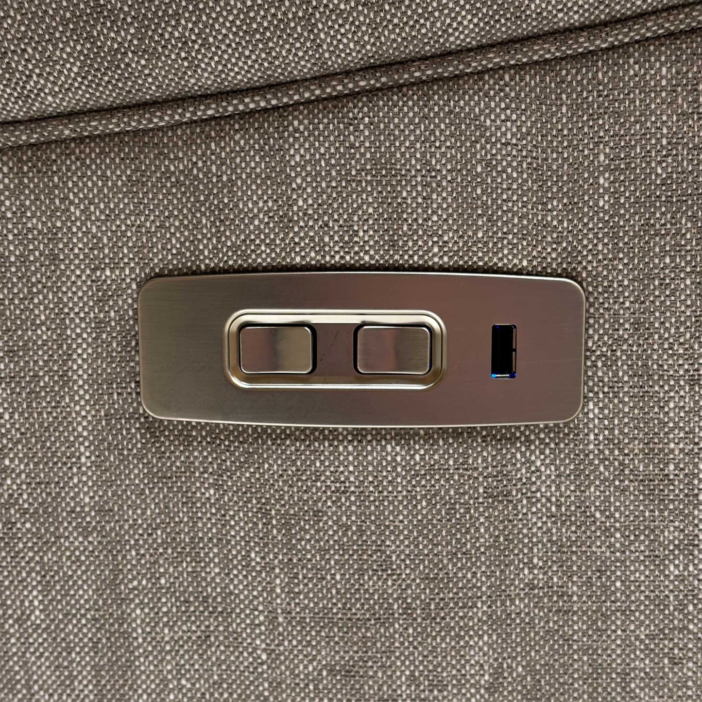 Close-up of the integrated brushed chrome side control panel, featuring intuitive buttons for seamless power recline adjustments.